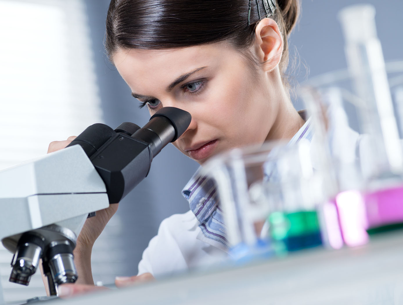 Female Researcher using Microscope